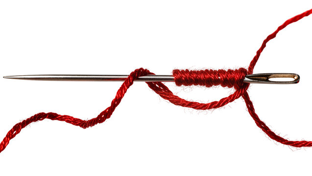 Isolated metal needle with vibrant red thread tightly wrapped around and through the eye.