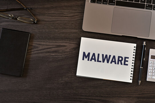 MALWARE Note on Desk with Security Tools &mdash; ideal for IT security and cyber threat awareness articles