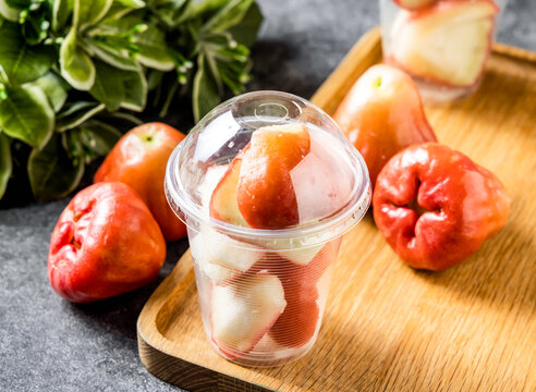 Fresh wax apples in a plastic cup. Sliced rose apples served as a healthy fruit snack.