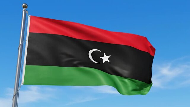 The national flag of Libya waves proudly against a clear blue sky