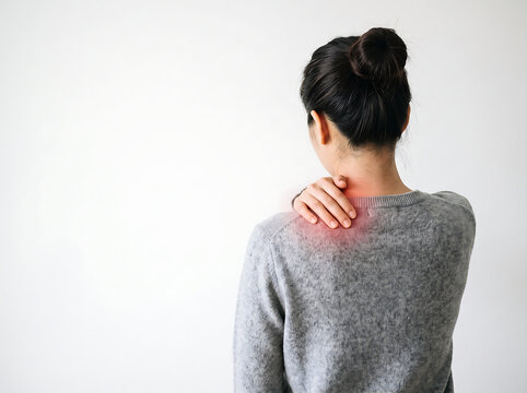 Woman holding painful neck and shoulder with red inflammation.