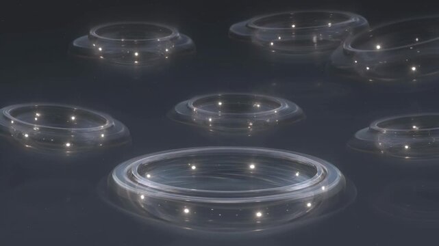 Abstract glowing glass rings floating in dark space creating ethereal light trails within this high quality digital motion video clip