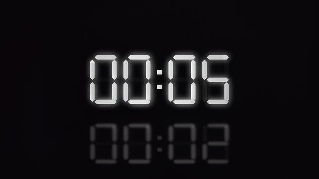 Digital timer display counting down seven seconds on black