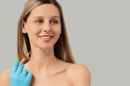 Young woman receiving a cosmetic injection in her jawline for beauty and anti-aging treatment