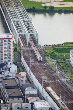 Train Crossing a Bridge Over a River Near a City