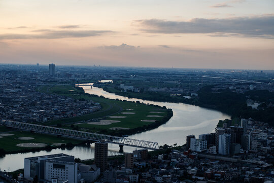 Aerial View of a Winding River and City at Sunset