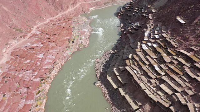 Aerial view of ancient salt drying fields in Yanjing, Tibet, near the Jinsha River, showcasing traditional salt making techniques.