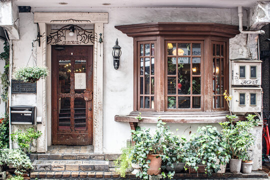 Charming Vintage Cafe Facade with Wooden Door and Bay Window