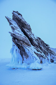 Spectacular landscape of the Dragon tail rock while snowing located at Ogoy island in frozen lake Baikal in winter season.