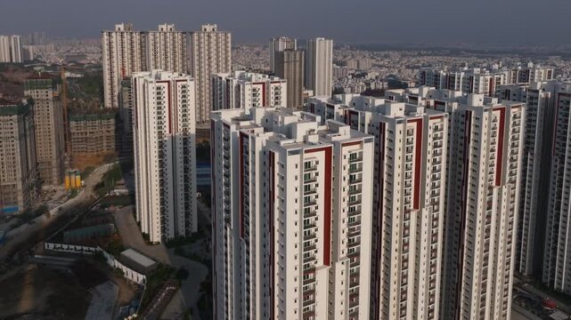 Aparna Zenon Tower buildings with under construction buildings and Sukhii Ubuntu apartments at Khajaguda, hyderabad, telangana, india. day time, arc shot, drone shot, 4k.