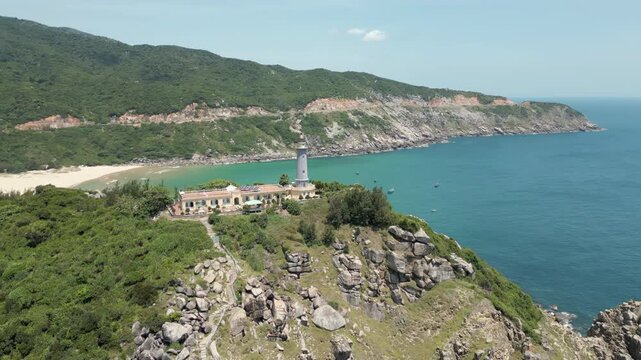 Lighthouse On Mui Dien Peninsula Surrounded By Mountains Bai Mon Beach Vietnam Drone Circling 4K 60FPS
