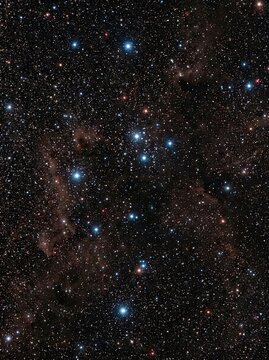 The image displays a stunning deep-sky photograph of the Perseus Cluster, a region of space filled with thousands of stars and a dark nebula.