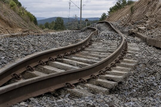 Twisted railway track disconnected from sleepers after an earthquake.