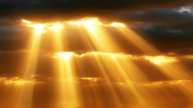 Bright golden sun rays breaking through dark storm clouds reflecting on calm water surface at sunrise or sunset