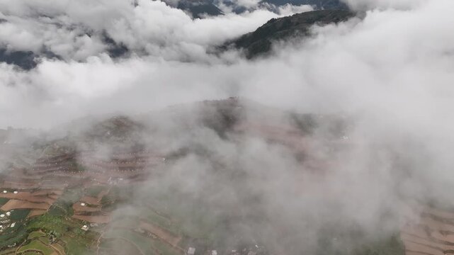 Aerial Orbiting Shot of Mountain Terraces and Vegetable Fields Shrouded in a Sea of Clouds in Atok