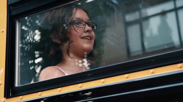 Girl looking out the school bus window