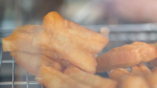 Golden Brown Deep Fried Dough Sticks in Glass Display Case