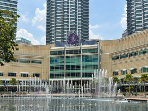 Kuala Lumpur, Malaysia - April 12, 2026: Suria KLCC Mall with Petronas Twin Towers and KLCC Park Lake Symphony Fountain