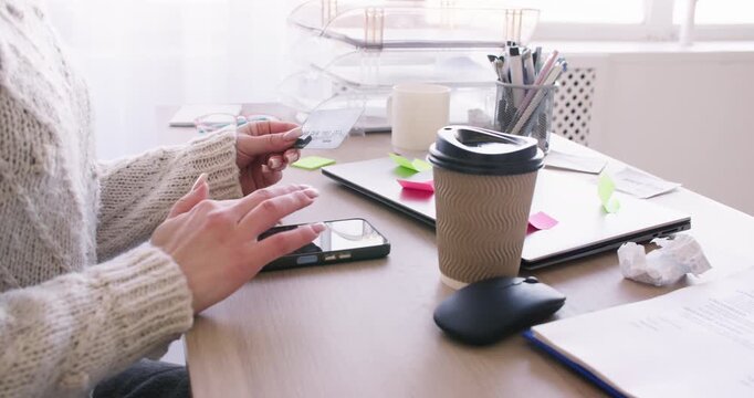 Online payment. Internet banking. Unrecognizable business female typing information on smartphone using credit card for digital transfer in office.