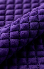Obraz premium A close-up view of a vibrant purple quilted fabric with a soft texture