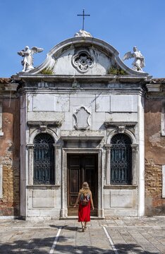 Tourist in red dress in front of a house, Murano, Murano Island, Venice, Veneto, Italy