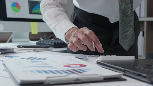 Financial analyst examining business data charts