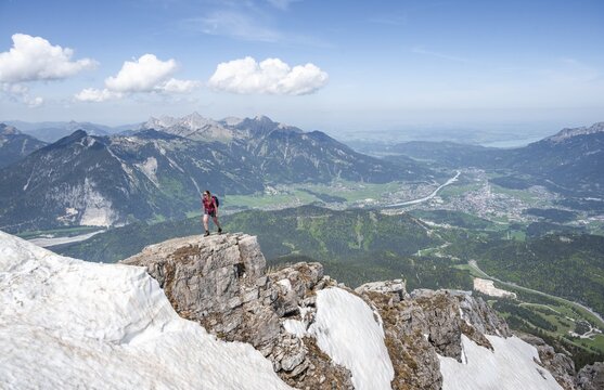 Hiker at a rock edge, view from Thaneller, eastern Lechtal Alps, Tyrol, Austria