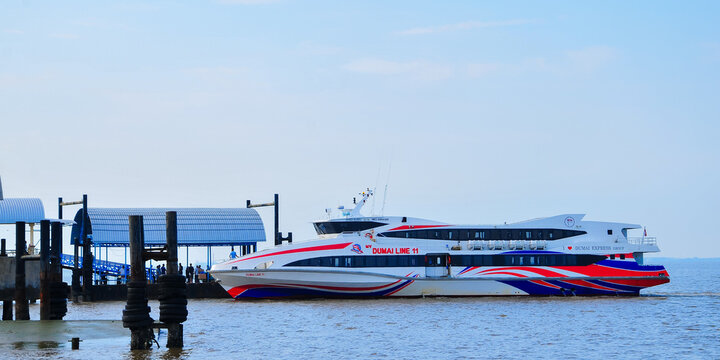 BATAM, INDONESIA - MARCH 15, 2026: high-speed passenger ferry boat sailing across blue ocean waters in the Riau Islands region. This fast ferry operates inter-island maritime tran