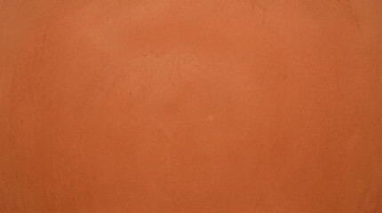 Fototapeta premium Burnt orange smooth plaster wall texture background for bold interior design