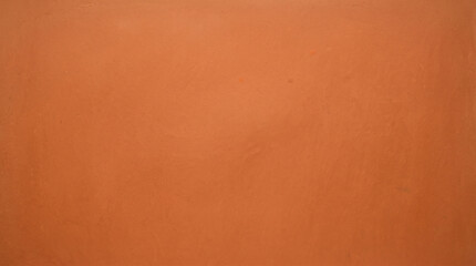 Fototapeta premium Vibrant orange smooth plaster wall texture background for bold warm design