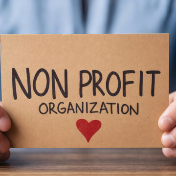 non profit organization sign on wooden desk charity mission vision concept community service volunteer dedication corporate social responsibility csr initiative giving back to society helping hands su