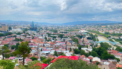 Historic Tbilisi spreads along the Kura River in Georgia, combining old neighborhoods, churches, bridges and business towers © chekart