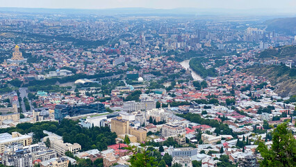 Tbilisi spreads across the Kura River valley in a high-angle city view, combining historic districts, civic landmarks © chekart