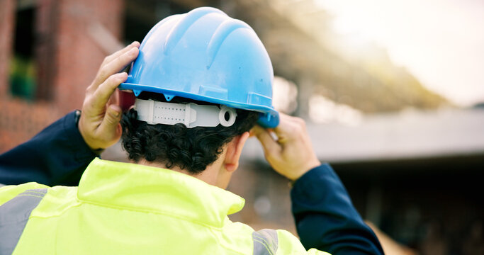 Construction, helmet or man on site with safety, protection gear or equipment in building project. Compliance, back or hardhat for risk control, ppe or hazard prevention in industrial industry.