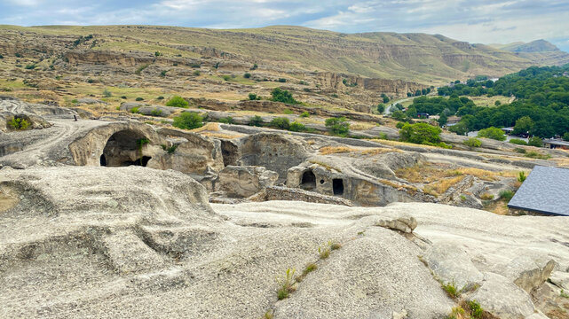 Elevated overview of Uplistsikhe presents caves, pathways, ruins, and hills across the Georgian plateau