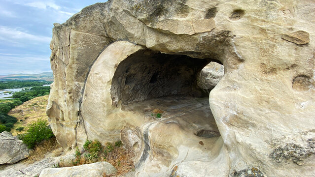 Rock-hewn room at Uplistsikhe shows an ancient sheltered living space shaped inside sandstone above the Georgian valley