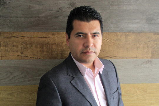 40-year-old Latino executive with a dark skin, successful leader of his business and finance venture