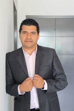 40-year-old Latino executive with a dark skin, successful leader of his business and finance venture