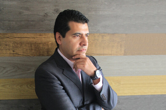 40-year-old Latino executive with a dark skin, successful leader of his business and finance venture