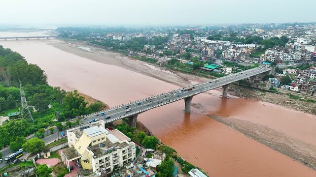 Jammu floods and monsoon risk: aerial over Tawi bridge, Gujjar Nagar flood prone housing and poor urban planning on riverbank