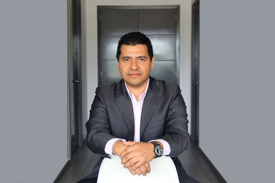 40-year-old Latino executive with a dark skin, successful leader of his business and finance venture