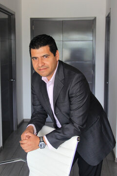 40-year-old Latino executive with a dark skin, successful leader of his business and finance venture