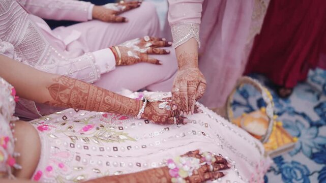 Close up of elder applying haldi paste on bride hands