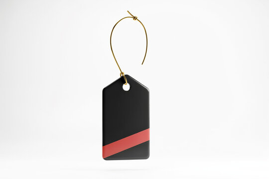 A sleek black price tag displaying a prominent bold red fifty percent off discount symbol with a subtle three dimensional effect suspended from a delicate shiny golden string