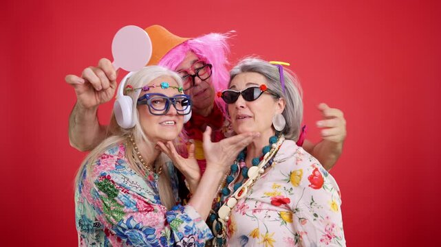 Senior friends having fun at a party wearing costumes