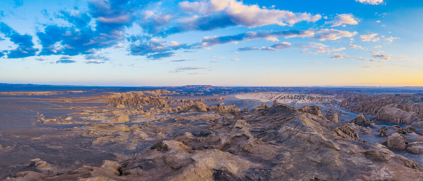 Aerial view of yardang landforms in the desert during golden hour sunset, Dahaidao, Xinjiang, China