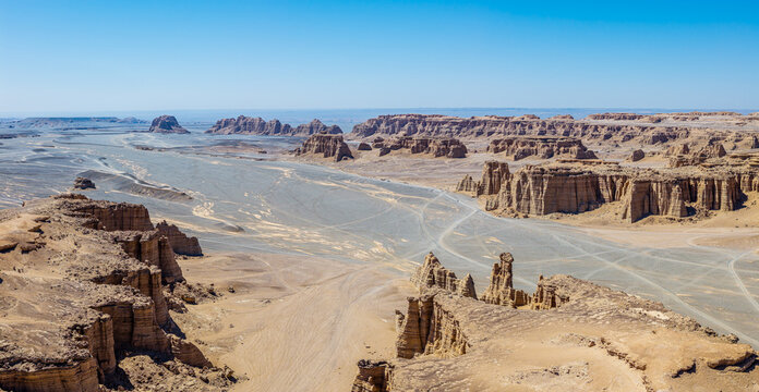 Aerial view of vast yardang landforms with dry riverbeds and clay canyons in Dahaidao, Gobi Desert, Xinjiang, China
