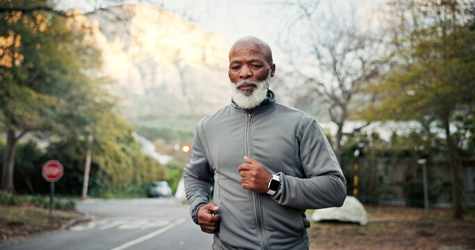 Serious, man and running on road, training and endurance for physical activity or cardio for fitness. Outdoor, mature runner and black person on street, wellness and workout routine to lose weight
