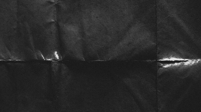 Gritty folded black paper texture overlay with distressed creases, grunge analog scan surface and vintage film grain, realistic worn background for photo editing, posters and creative design
