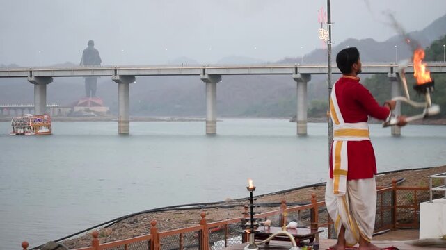 Narmada Aarti ceremony near Statue of Unity in Ekta Nagar, showcasing Hinduism, sacred fire rituals, Ganga Aarti traditions and spiritual tourism along the serene Narmada River at dusk in Gujarat now.